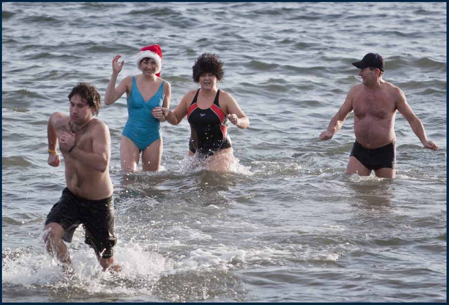 people running in the sea