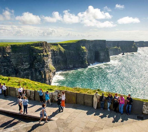 Tourists enjoying the view from the observation area at the cliffs of moher.