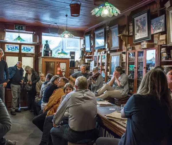 A lively pub scene with patrons enjoying live music.