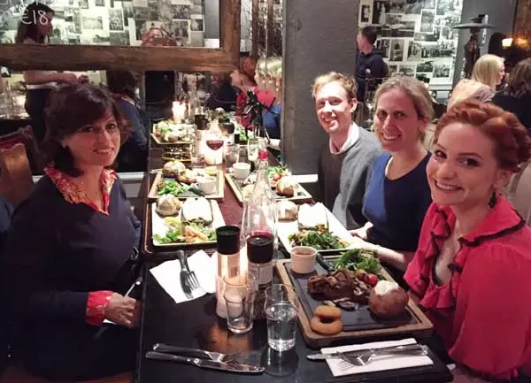 Group of people enjoying a meal at a restaurant.