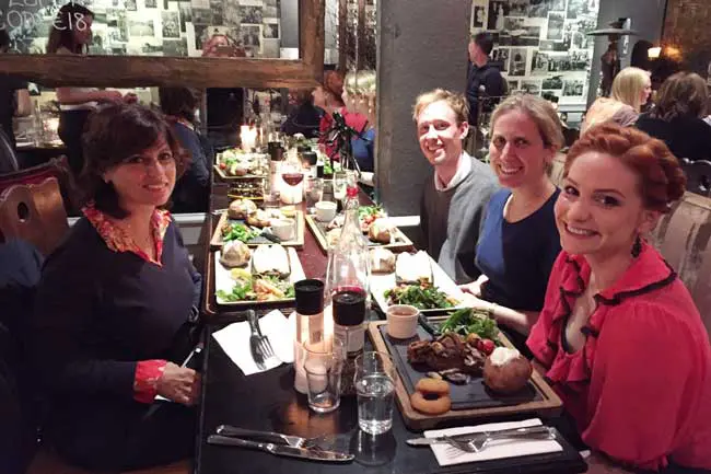 Group of people enjoying a meal at a restaurant.