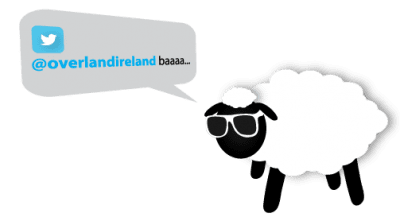 A cartoon sheep wearing sunglasses with a speech bubble referencing the twitter handle @overlandireland and saying "baaaa... join us for Private Tours across Ireland.