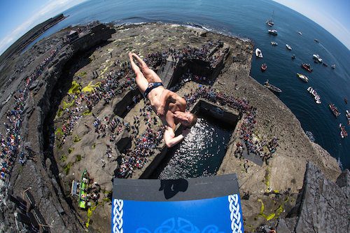 Diver taking the plunge during the Red Bull Cliff diving event on our Wild Atlantic Way Tour