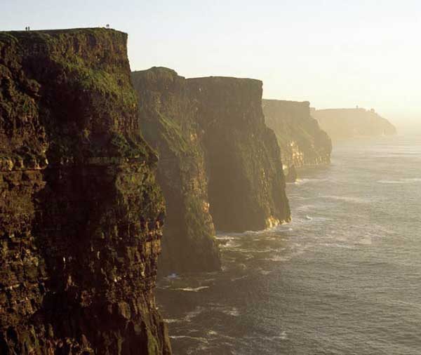 Sunset view of the cliffs of moher along the irish coastline.