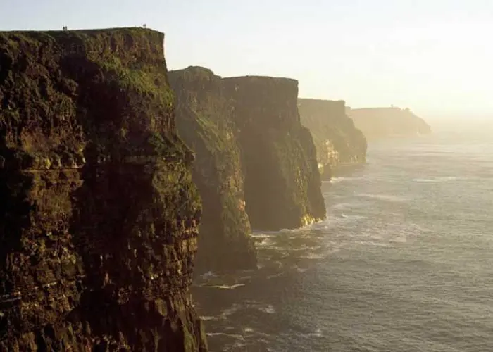 Sunset view of the cliffs of moher along the irish coastline.