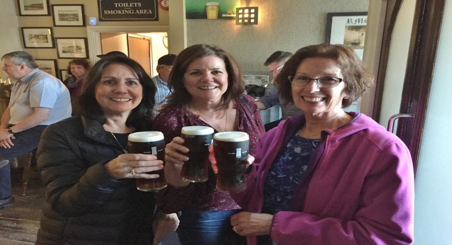 Three women enjoying a drink in a pub in Ireland