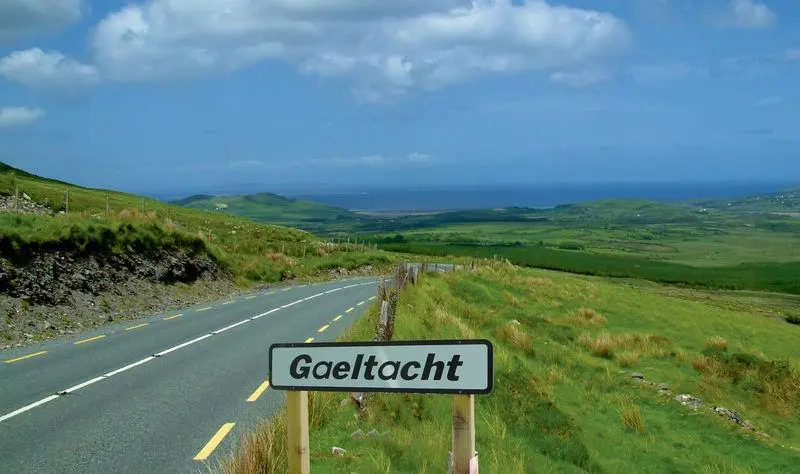 Road with a sign displaying Gaeltacht, Ireland