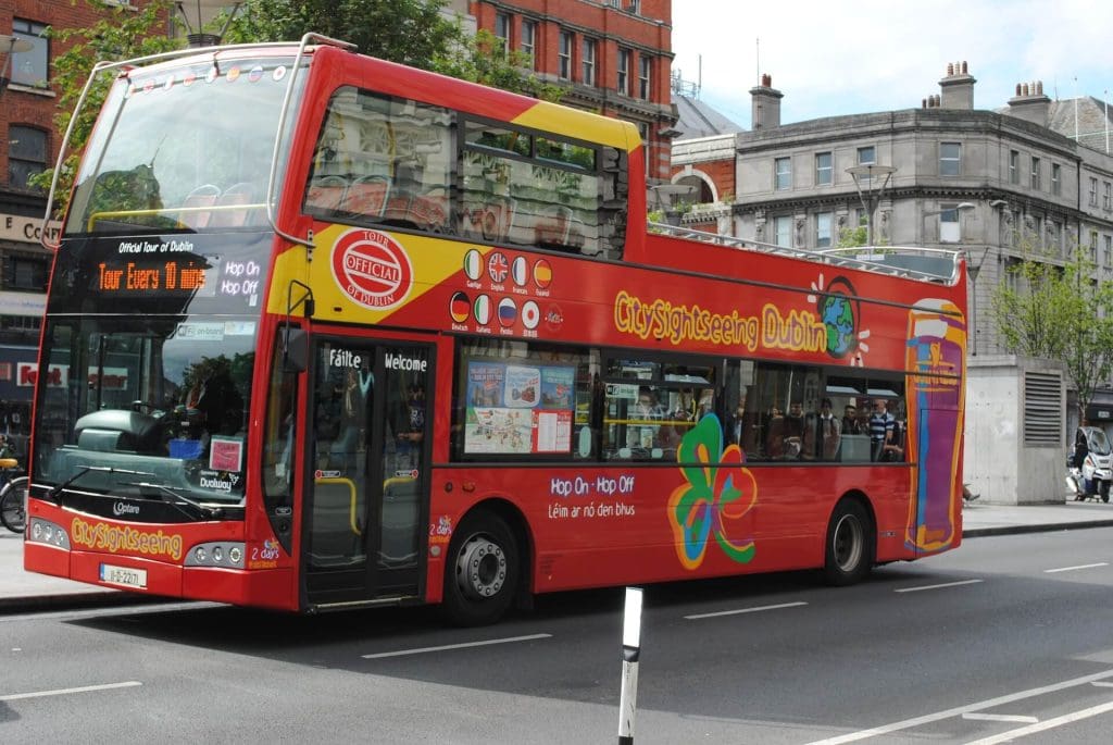 red hop on hop off bus with people