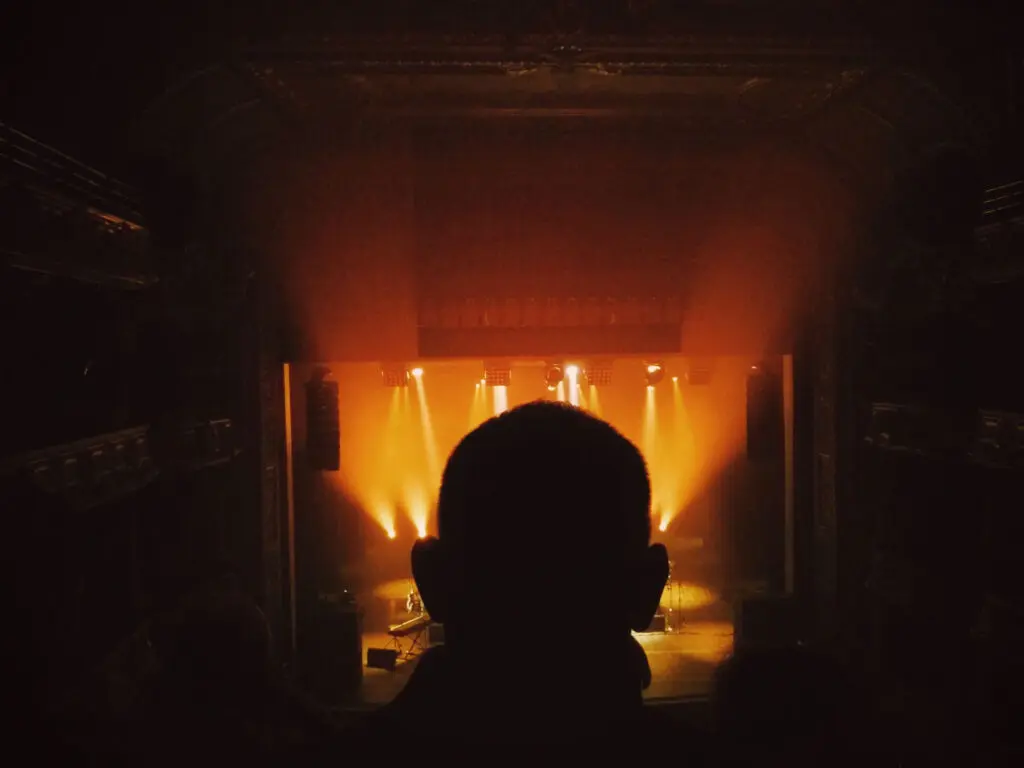 Person backlit in a theater