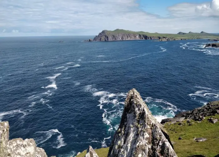 Rugged coastline with jagged cliffs overlooking a turbulent ocean.