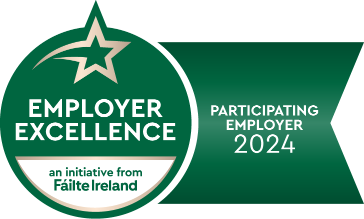 Green badge logo indicating "employer excellence," an initiative from Fáilte Ireland, with a participating employer for Ireland Tours in the year 2024.